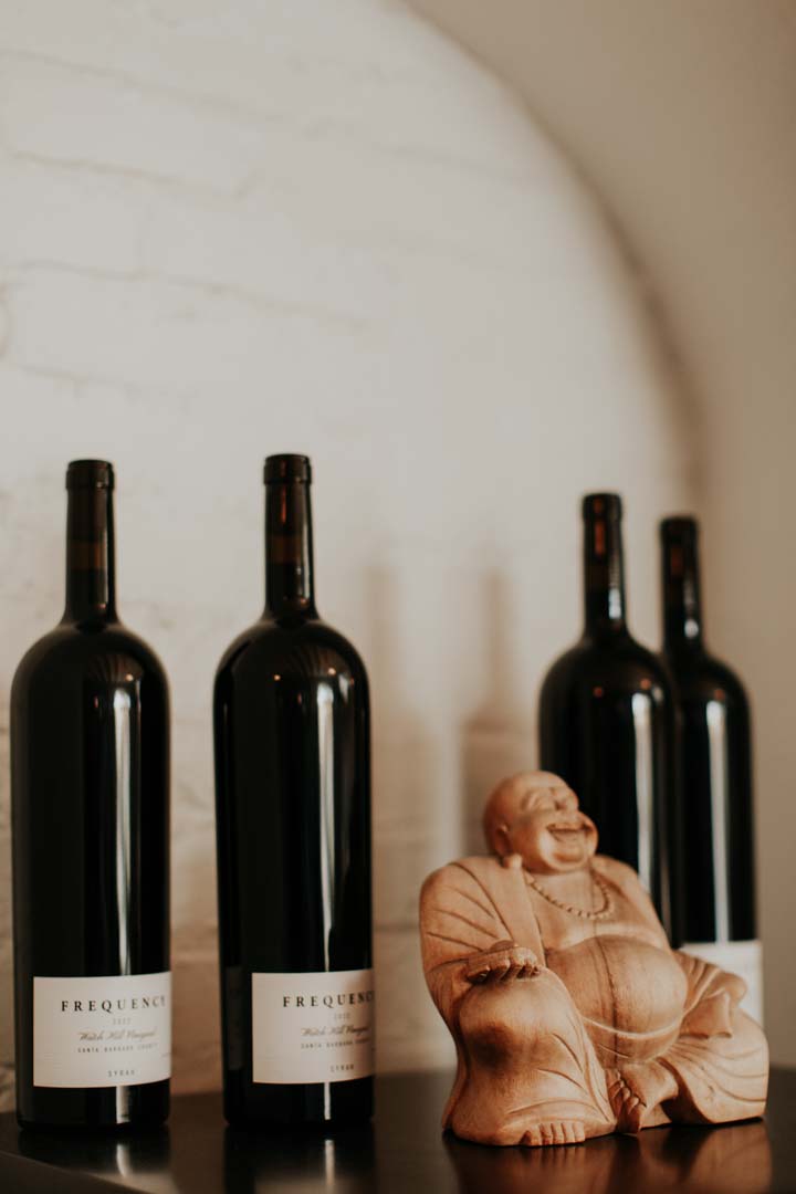 Magnum bottles next to a happy statue of Buddha
