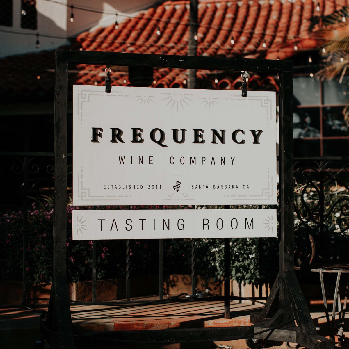 A sign in front of our Tasting Room that reads "Frequency Wine Company"