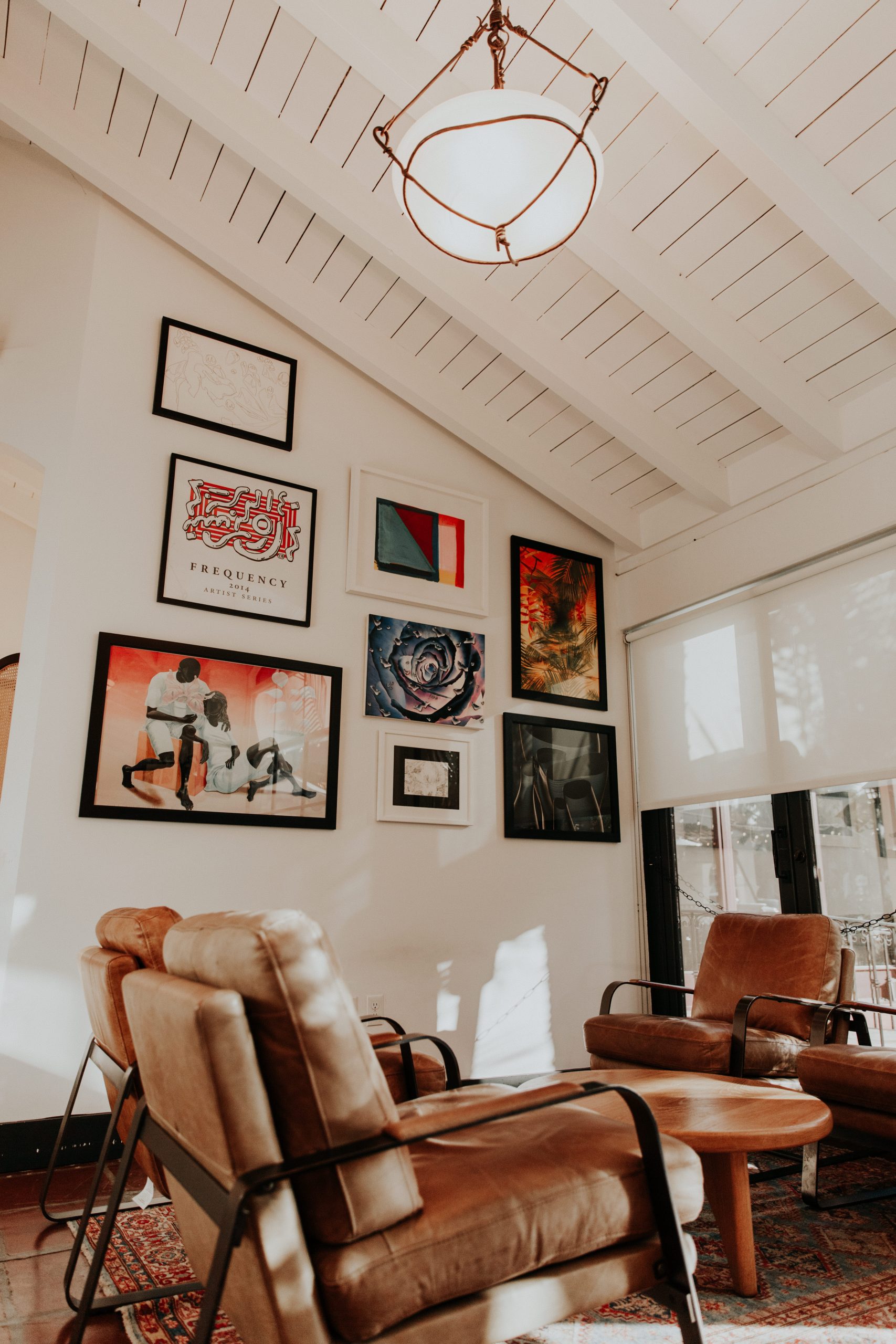 Leather lounge chairs and framed artwork inside Frequency’s Santa Barbara tasting room