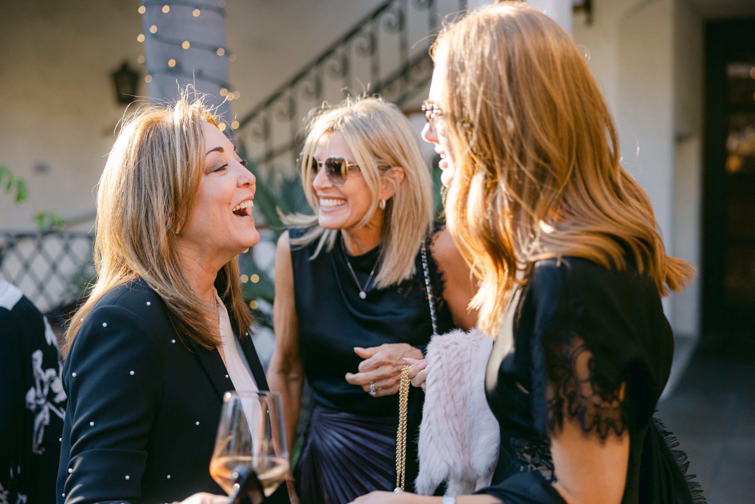 Guests sharing a conversation at a Frequency wedding welcome party