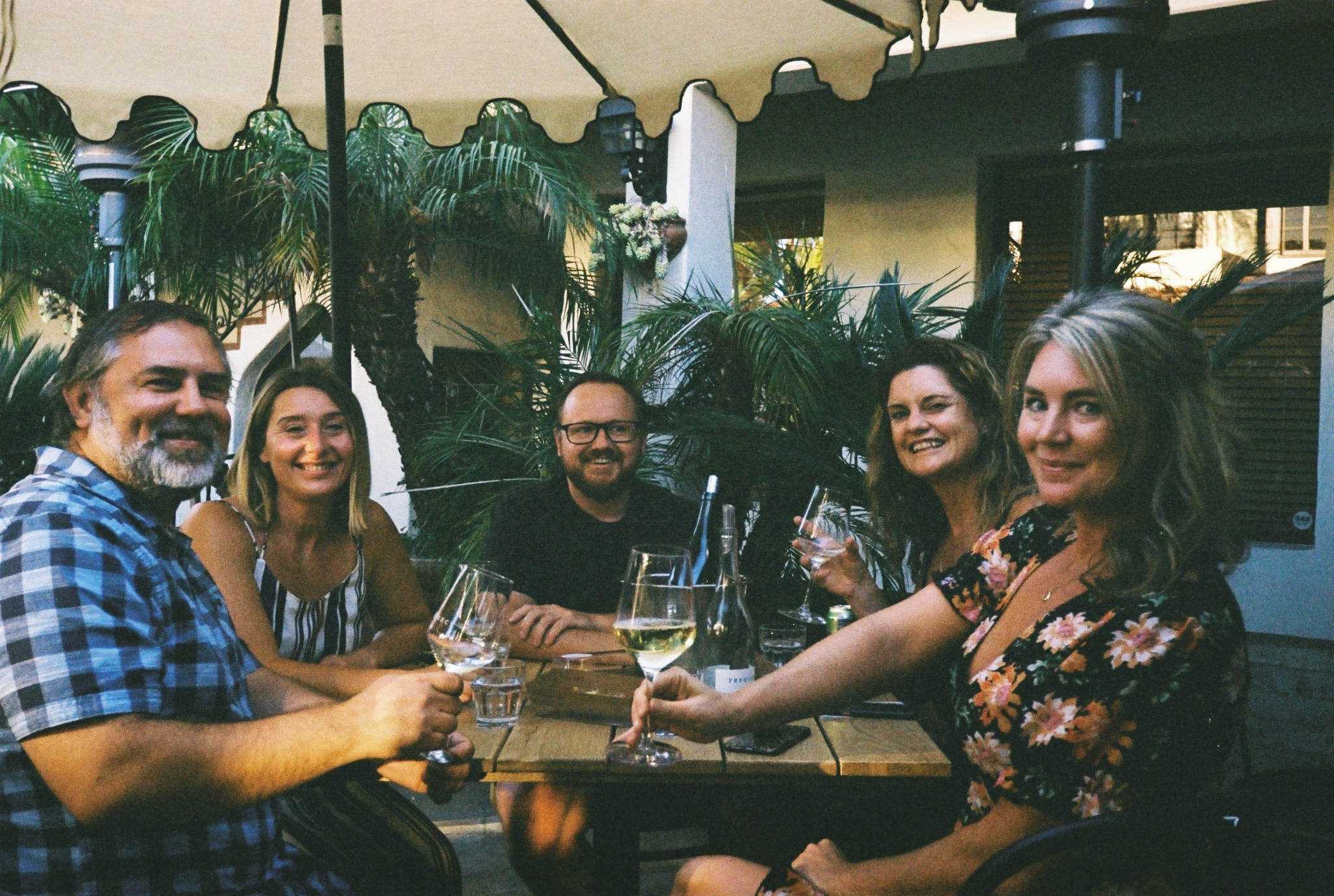 Guests enjoying wine together on Frequency’s patio